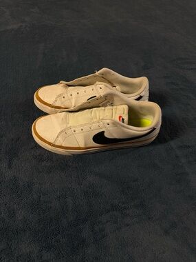 Nike White Low-Top Sneakers with Black Swoosh and Tan Trim